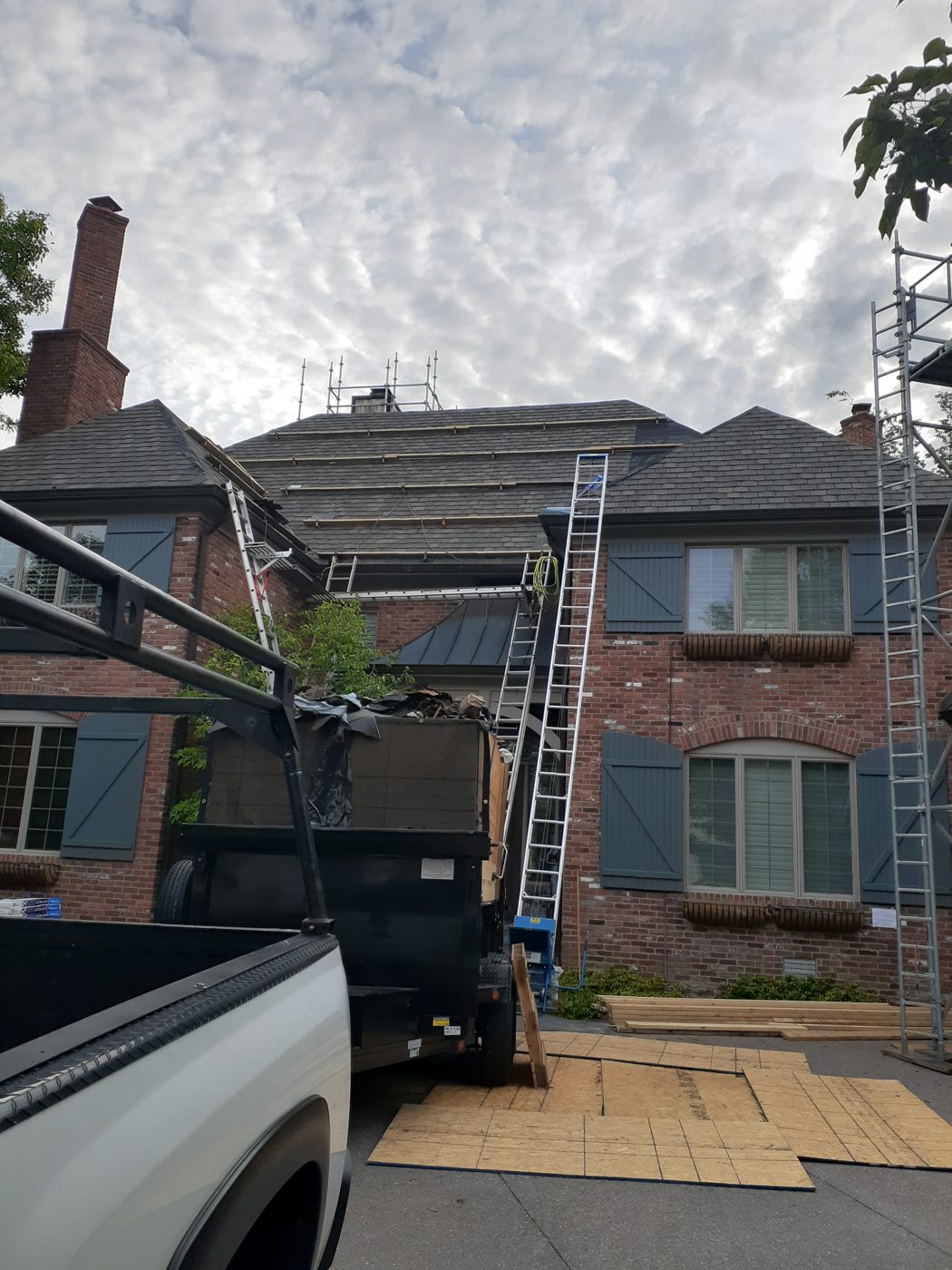 Ryan Irwin Construction crew at work on a brick home roofing project